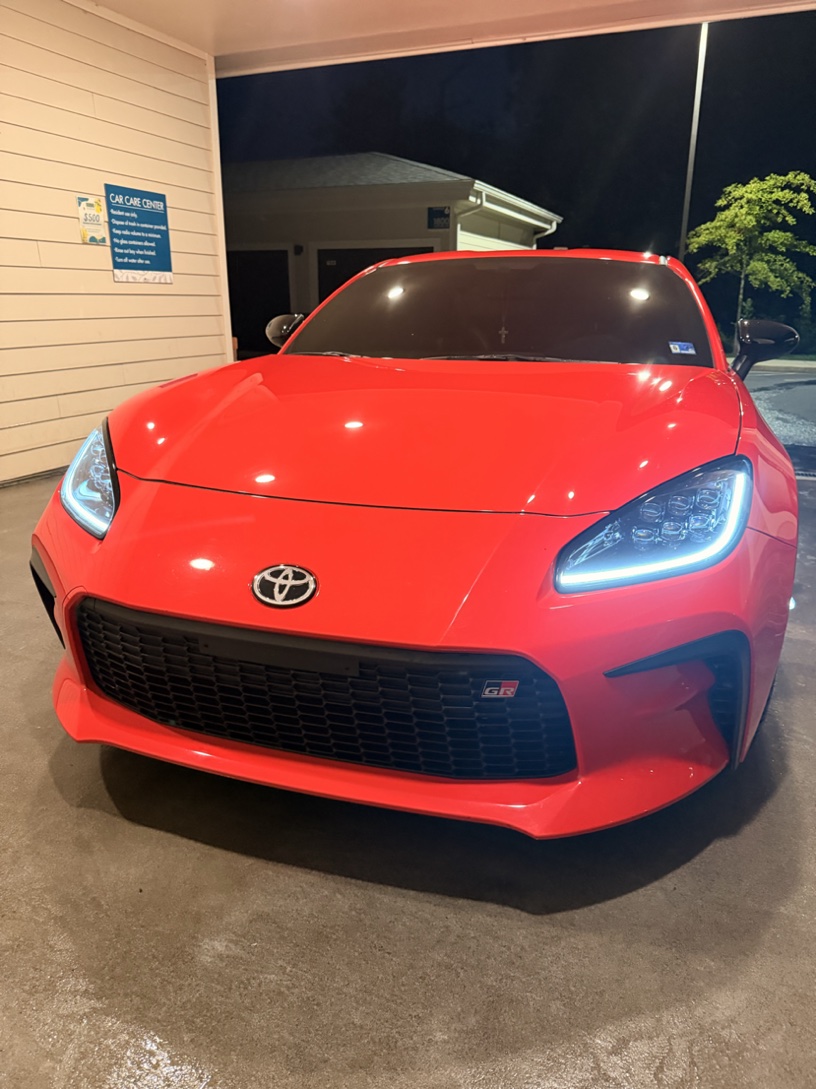 Red Toyota GR86 with a mirror-like finish at night